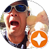 Person in sunglasses making a surprised face next to a stuffed animal.
