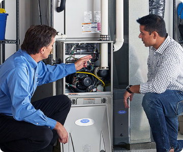 Plumbers working on a furnace repair together