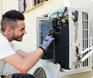 technician checking out the inside of an AC unit